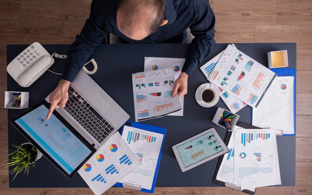 Top view of businessman pointing at financial statistics